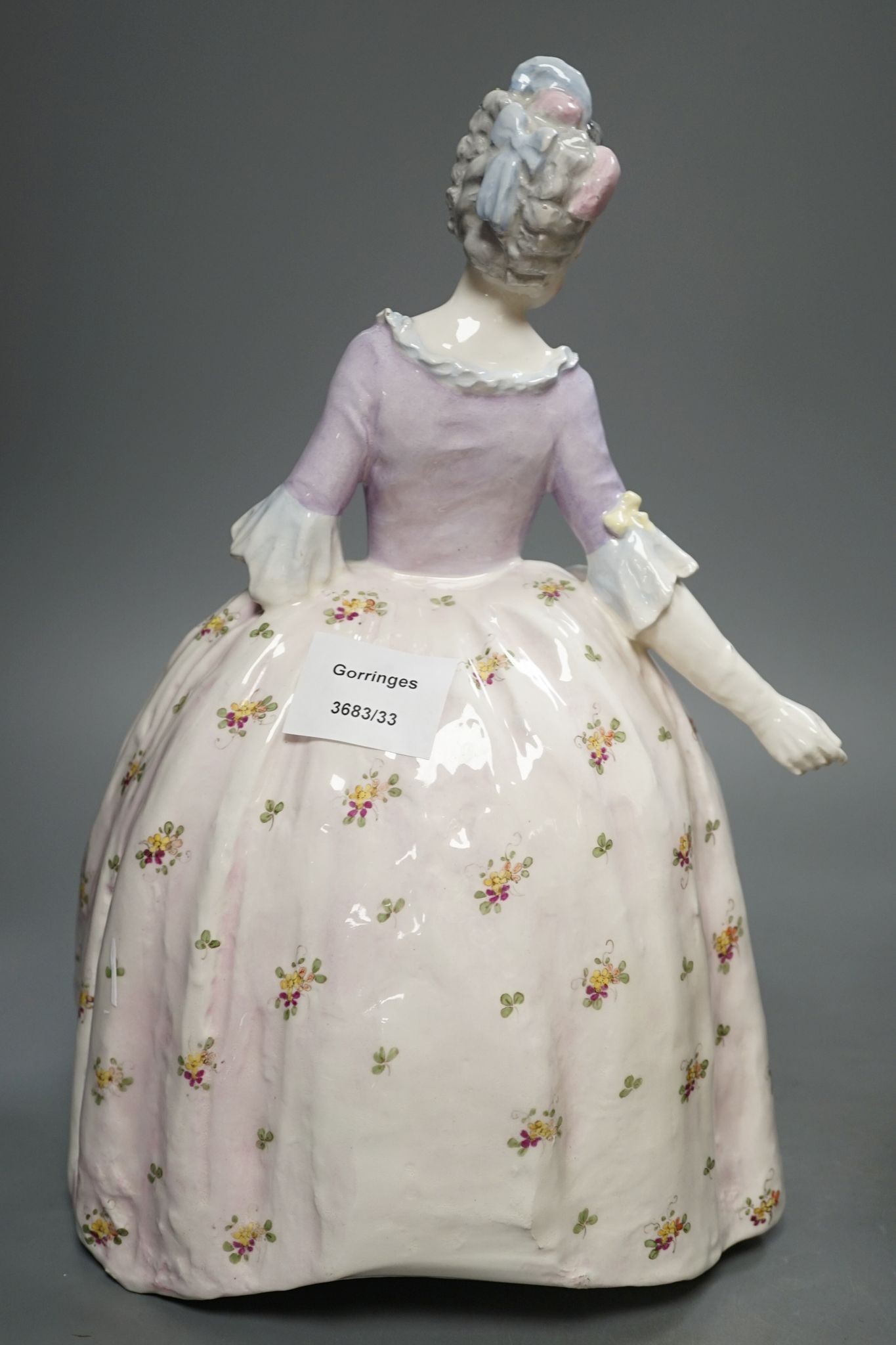 An Italian porcelain group of a dancing couple, 31cm, and an Italian maiolica figure of a lady